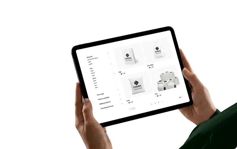 A person holding a black tablet displaying the Fadwa Non Woven product catalog interface, showcasing various customizable options for non-woven bags, rolls, and material specifications.