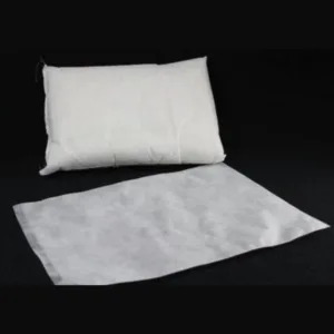 A clean white pillow covered in durable non-woven fabric ticking, displayed against a dark background.